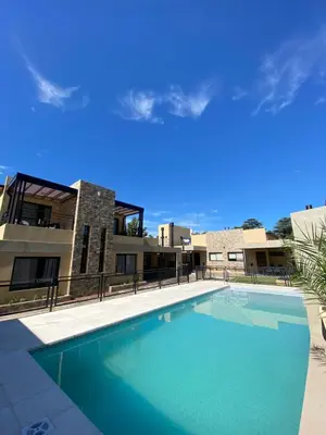 a large swimming pool in front of a building at Solana Apart in Mina Clavero