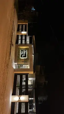 a tall building with a sign on it at night at Solana Apart in Mina Clavero