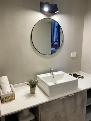 a bathroom with a white sink and a mirror at Solana Apart in Mina Clavero