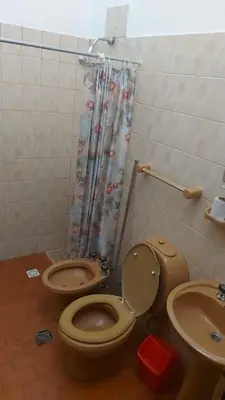 a bathroom with a toilet and a sink at Casa Pileta Exclusiva A 40 Mtrs Rio Y 2 Minutos Del Centro in Villa Carlos Paz