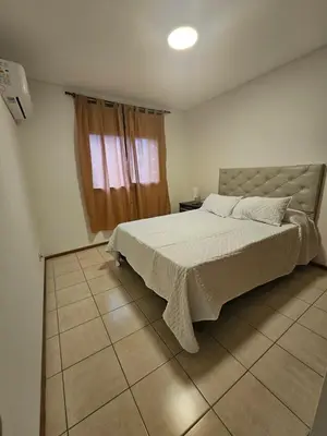 a bedroom with a large bed and a window at Alto Parana Depto en Nueva Cordoba! in Cordoba