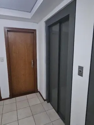 an empty room with two doors and a tile floor at Alto Parana Depto en Nueva Cordoba! in Cordoba
