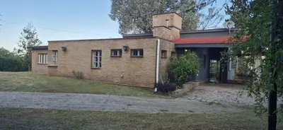 a brick house with a chimney on top of it at Nautilus in Villa Icho Cruz