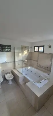 a large bathroom with a tub and a toilet at Nautilus in Villa Icho Cruz
