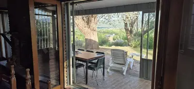 a glass door of a patio with a table and chairs at Nautilus in Villa Icho Cruz