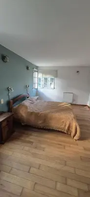 a bedroom with a large bed and a wooden floor at Nautilus in Villa Icho Cruz