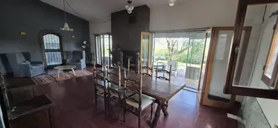 a living room with a wooden table and a dining room at Nautilus in Villa Icho Cruz