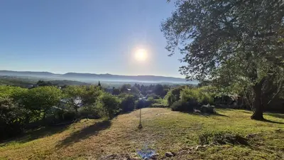 a view of a field with the sun in the sky at Nautilus in Villa Icho Cruz