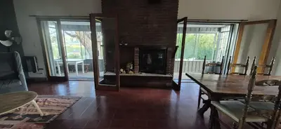 a living room with a table and a fireplace at Nautilus in Villa Icho Cruz