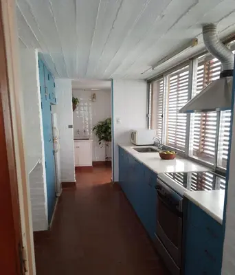 a kitchen with blue cabinets and a white counter top at Casa Lac - Vista al Lago - No se aceptan grupos de jóvenes in Villa Carlos Paz