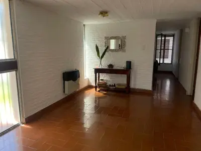 an empty room with a tile floor and a table at Casa Lac - Vista al Lago - No se aceptan grupos de jóvenes in Villa Carlos Paz