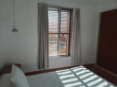 a bedroom with a bed and a window at Casa Lac - Vista al Lago - No se aceptan grupos de jóvenes in Villa Carlos Paz