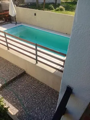 a swimming pool in front of a building at Complejo José León in Arroyo de Los Patos