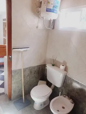 a small bathroom with a toilet and a sink at Complejo José León in Arroyo de Los Patos