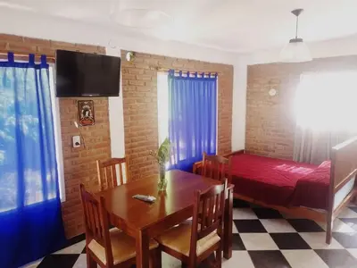 a room with a dining room table and a bed at Complejo José León in Arroyo de Los Patos