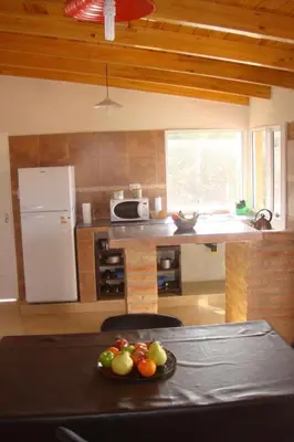 a kitchen with a table with a plate of fruit on it at Cerritos Departamento in Villa Carlos Paz