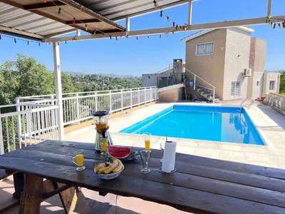 a picnic table with a bowl of fruit and drinks on a patio at Cerritos Departamento in Villa Carlos Paz