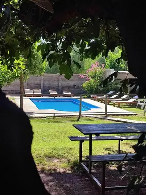 a picnic table in front of a swimming pool at Residencial Buenos Aires in Mina Clavero