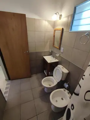 a bathroom with a toilet and a sink at Residencial Buenos Aires in Mina Clavero