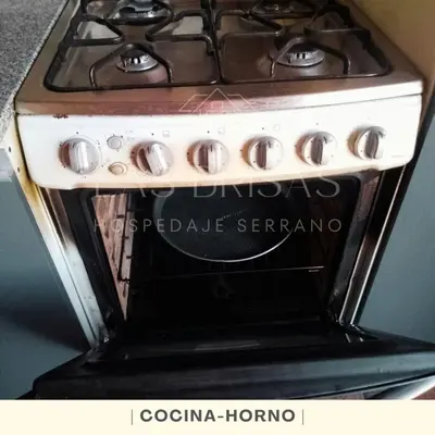 a stove top oven in a kitchen with at Las Brisas - Hospedaje Serrano in Santa María