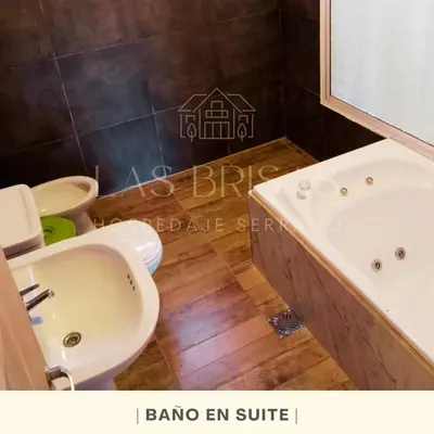 a bathroom with a sink and a tub and a toilet at Las Brisas - Hospedaje Serrano in Santa María