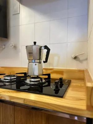 a coffee pot on top of a stove in a kitchen at Duplex peatonal in Villa Carlos Paz