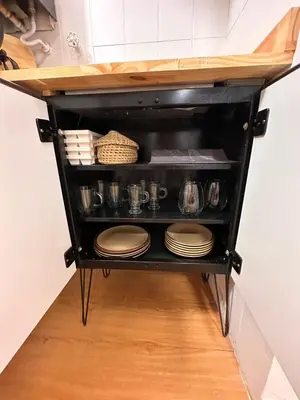 a kitchen cart with plates and dishes on it at Duplex peatonal in Villa Carlos Paz
