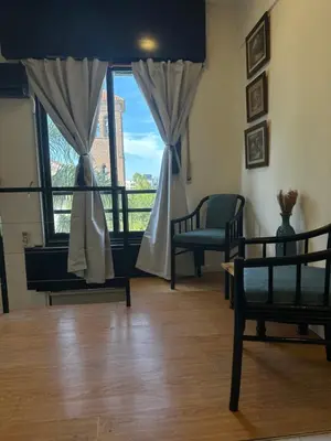 a living room with two beds and a window at Duplex peatonal in Villa Carlos Paz