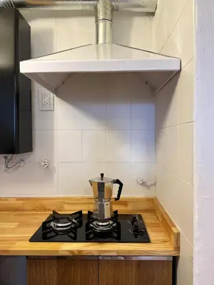 a tea kettle sitting on top of a stove in a kitchen at Duplex peatonal in Villa Carlos Paz