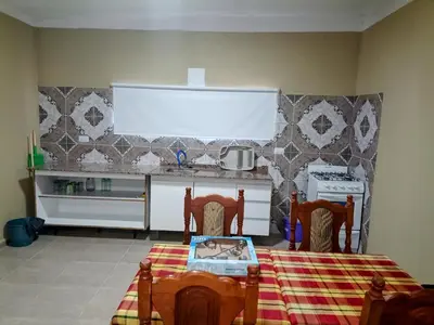 a kitchen with a table and two chairs and a stove at Atardecer Serrano in Nono