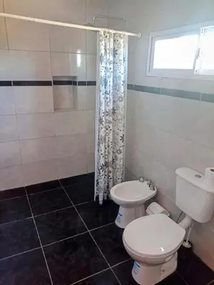 a bathroom with a toilet and a shower at Atardecer Serrano in Nono