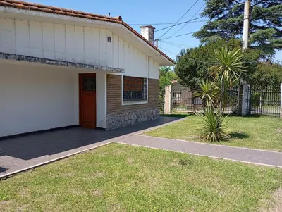 a house with a porch and a driveway at Casa Ranqueles in Villa Carlos Paz