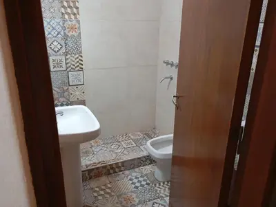 a bathroom with a toilet and a sink at Casa Ranqueles in Villa Carlos Paz