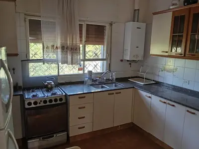 a kitchen with a sink and a stove top oven at Casa Ranqueles in Villa Carlos Paz