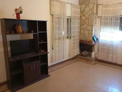 a living room with a television on a shelf at Casa Ranqueles in Villa Carlos Paz