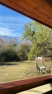 a view from a window of a picnic table and bench at Puesto de Montaña - Casa con pileta privada in Los Hornillos