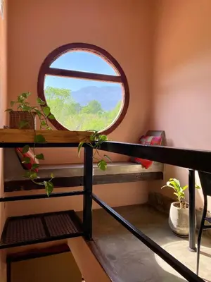 a room with a round window on a balcony at Puesto de Montaña - Casa con pileta privada in Los Hornillos