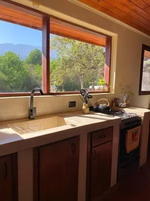 a kitchen with a sink and a window at Puesto de Montaña - Casa con pileta privada in Los Hornillos