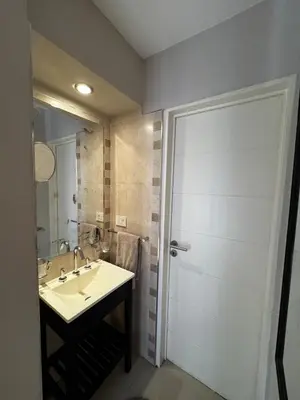 a bathroom with a sink and a shower with a mirror at Beautiful apartment in Cordoba