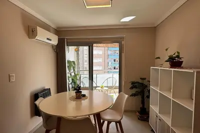 a dining room with a table and chairs and a window at Beautiful apartment in Cordoba