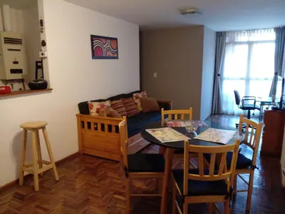 a living room with a table and a couch at Corazón de Nueva Córdoba in Cordoba