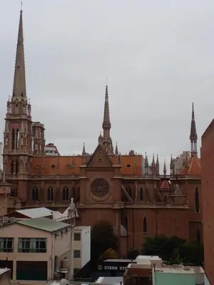 a large brick building with a clock tower on it at Corazón de Nueva Córdoba in Cordoba