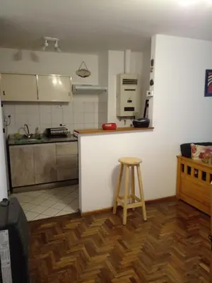 a kitchen with a counter and a stool in a room at Corazón de Nueva Córdoba in Cordoba