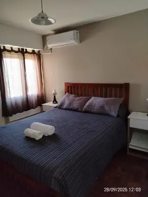 a bedroom with a bed with two towels on it at Corazón de Nueva Córdoba in Cordoba