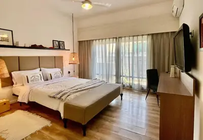 a bedroom with a large bed and a television at Tu Lugar en Cordoba in Cordoba