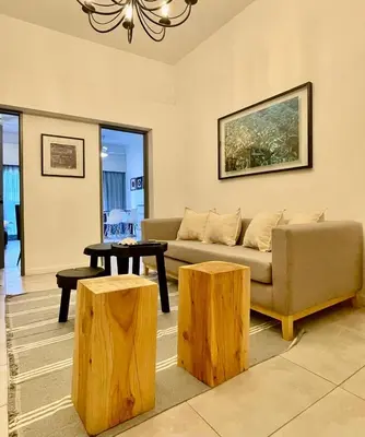 a living room with a couch and two logs at Tu Lugar en Cordoba in Cordoba