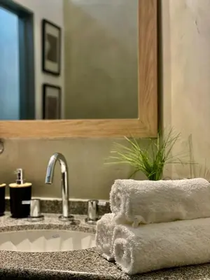 a bathroom sink with towels and a mirror at Tu Lugar en Cordoba in Cordoba