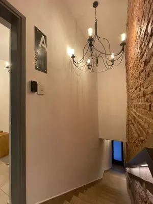 a hallway with a chandelier hanging from a wall at Tu Lugar en Cordoba in Cordoba