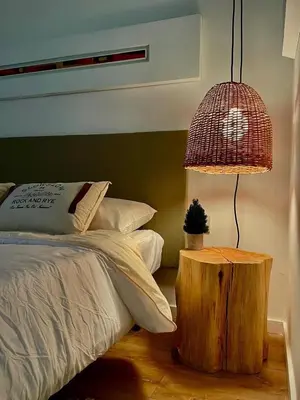 a bedroom with a bed and a table with a lamp at Tu Lugar en Cordoba in Cordoba