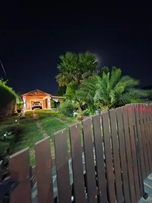 a fence in front of a house at night at Hospedaje Del Rosario in Santa María